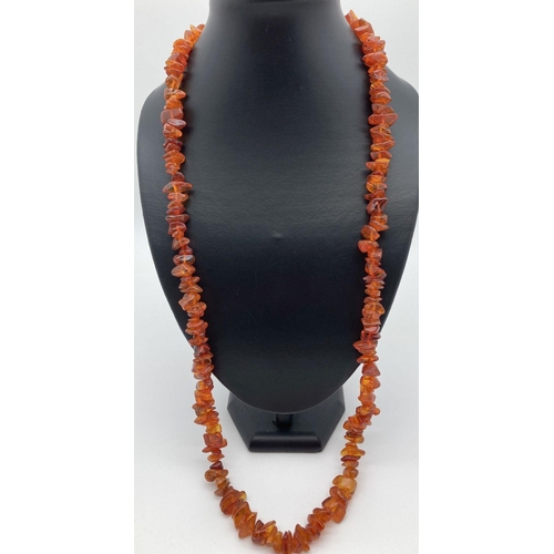 195 - A 36 inch costume jewellery necklace of cognac amber chip beads.