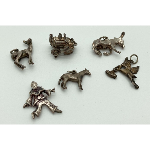 202 - 6 vintage silver and white metal charms. Comprising: a steam engine, a clown, a donkey, a horse, sto... 