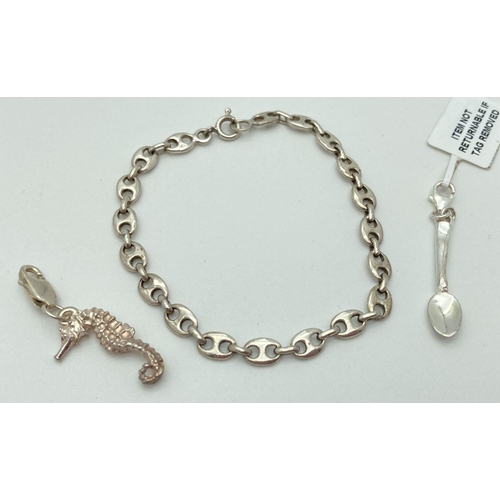 203 - A mariners link silver bracelet together with a seahorse charm and a spoon charm, both with lobster ... 