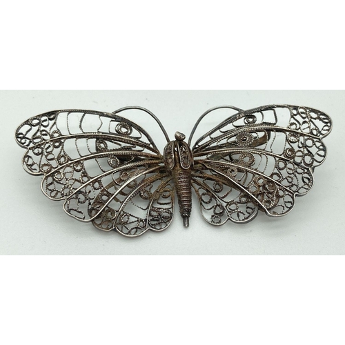 206 - A large vintage filigree silver butterfly brooch. Foreign silver marks to pin. Brooch approx. 7.5 x ... 