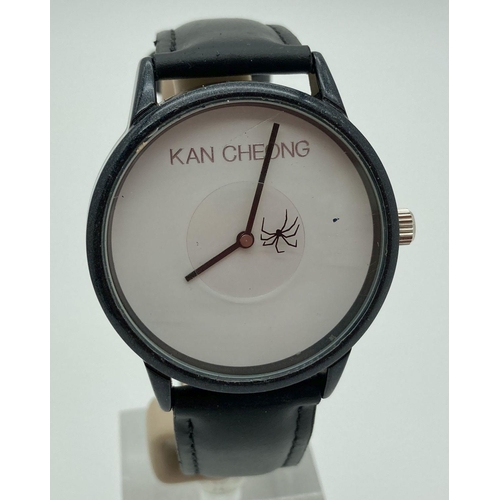 295 - A Spider wristwatch by Kan Cheong. White face with black hour and minutes hand. Seconds hand is a ro... 