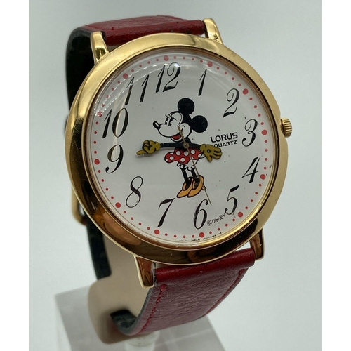 296 - A Disney Minnie Mouse quartz wristwatch with red leather strap. Minnie's hands are the hour and minu... 