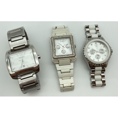 307 - 3 wristwatches by Next. All with stainless steel bracelet straps. A square face with silver tone hou... 