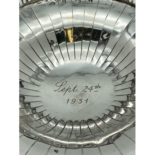 335 - A 1920's silver bon bon dish with galleried rim and raised on a pedestal foot. Engraved to base of b... 