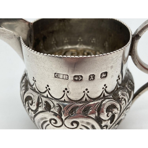 339 - A small Victorian silver cream jug decorated with scrolls and waves of foliage. Loop design handle s... 