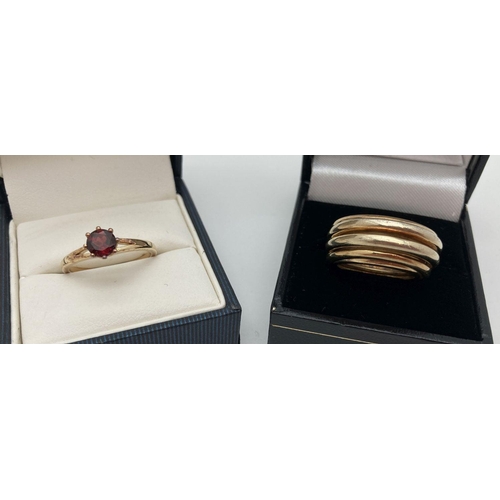 281 - 2 modern silver gilt dress rings. A multi band style ring together with a garnet set solitaire ring.... 