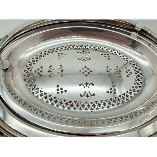 346 - An antique silver plated, oval shaped, revolving dome toped warming dish. With decorative floral and... 