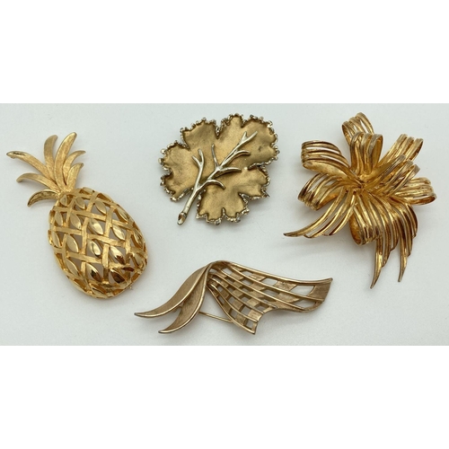 283 - 4 vintage gold tone brooches in various designs and sizes to include Trifari abstract brooch and Exq... 