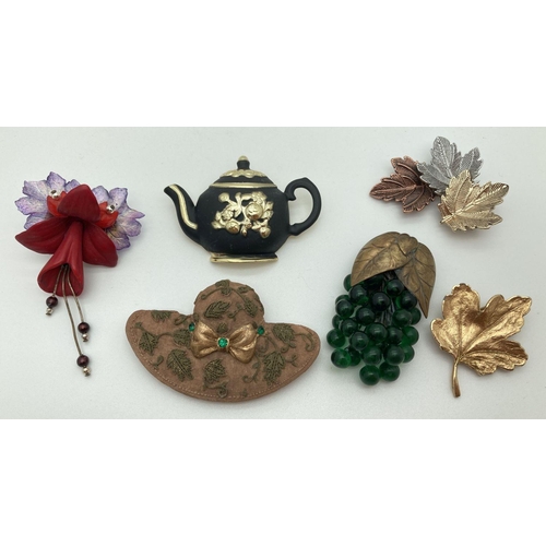 284 - 5 vintage brooches to include leaf design, teapot and fuchsia flower, together with an American vint... 