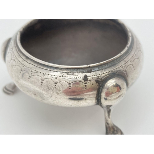 348 - A Victorian silver 3 legged salt with matching spoon, both have engraved pattern detail. Both pieces... 