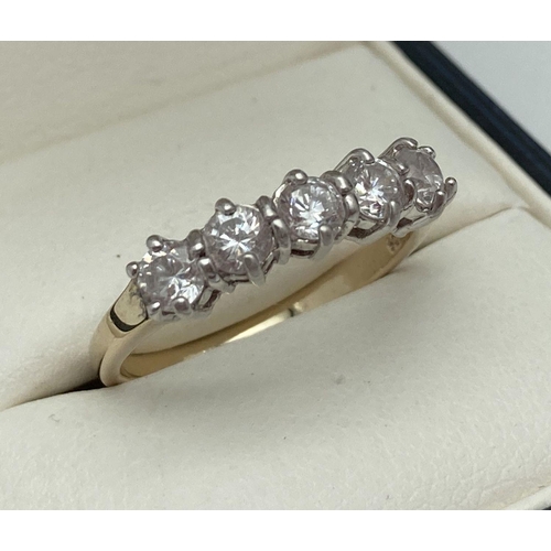 221 - A Gold on silver half eternity ring set with 5 round cut clear stones. Inside of band marked 925. Ri... 