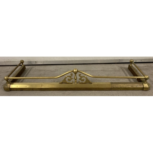 1013 - A vintage extending brass fire fender with finial, rail and scroll detail.