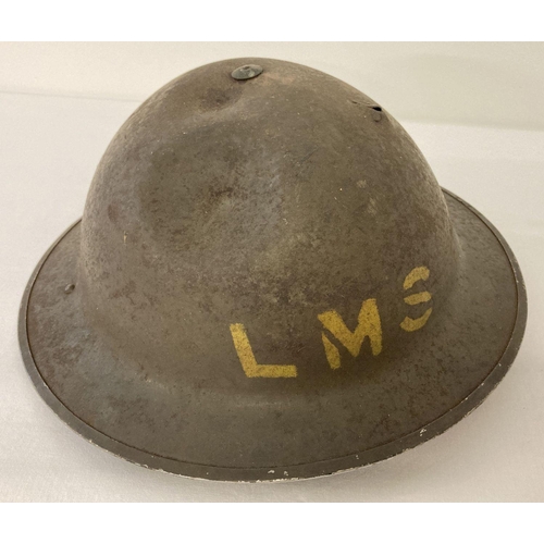 1039 - British MkII steel helmet painted khaki with stencilled 'LMS' (London Midland Scottish Railway). Let... 