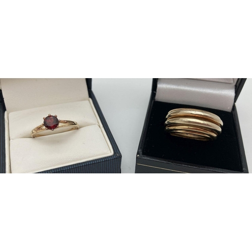 1010 - 2 modern silver gilt dress rings. A multi band style ring together with a garnet set solitaire ring.... 