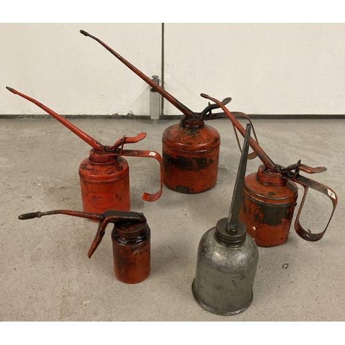 1239 - 5 vintage metal oil cans. 4 red painted lever style cans together with a dome style long spouted can... 