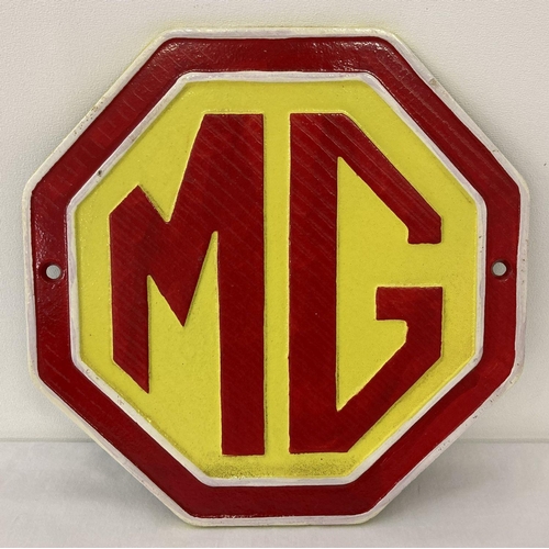 1241 - A painted cast iron octagonal shaped MG wall plaque.  In red, yellow and white and complete with fix... 