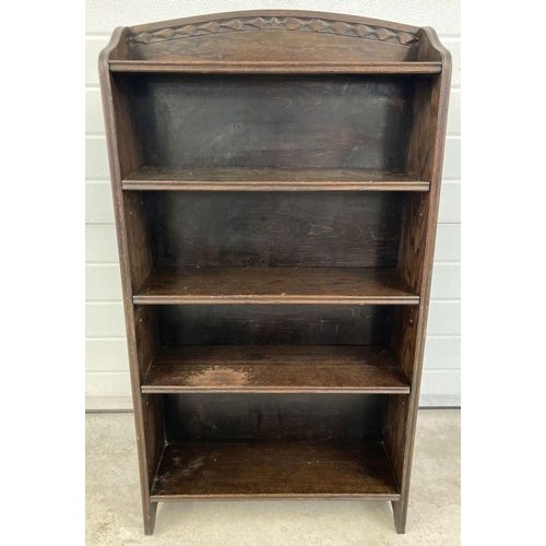 1363 - A vintage dark oak bookcase with adjustable shelves and carved detail to shaped top. Approx. 115 x 6... 