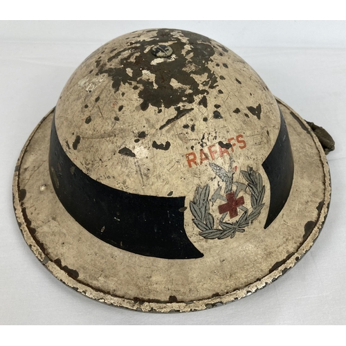 1125 - A British WWII 1940 MkII steel helmet painted white with circumferential black band. Hand painted le... 