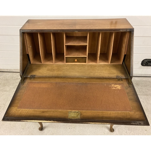 1387 - A vintage walnut veneer 2 drawer bureau, raised on cabriole legs. With interior stationary compartme... 