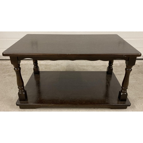 1388 - A vintage dark wood heavy coffee table with undershelf and turned detail to legs. Approx. 41cm tall ... 