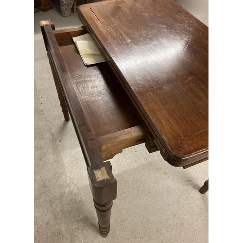 1392 - An Edwardian fold out mahogany table with pull out support legs to back revealing a hidden draw. Tan... 