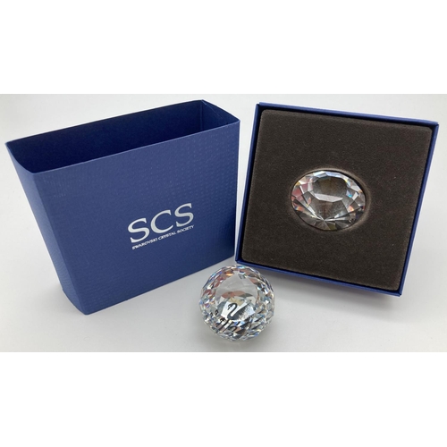 1201 - 2 Swarovski Crystal Society pieces. A boxed 2012 diamond renewal piece together with an unboxed Memb... 