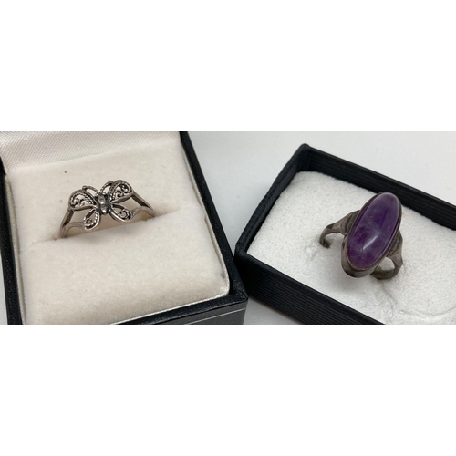 66 - 2 silver dress rings. A filigree style butterfly ring together with an oval cut amethyst cabochon se... 