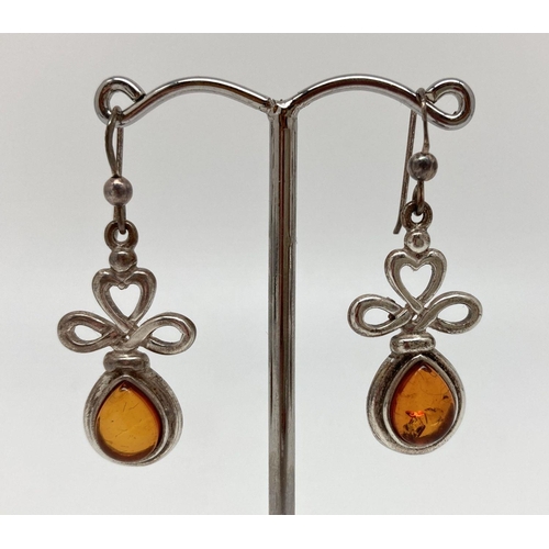 68 - A pair of silver and amber, modern design, drop style earrings with heart detail to mounts. Backs ma... 