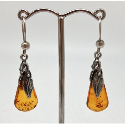 73 - A pair of silver and amber drop style earrings with feather decoration. Hooks marked 925. Approx. 4c... 