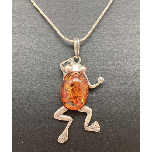 74 - A silver frog shaped pendant set with an oval cognac amber cabochon, on a 15 inch fine snake chain w... 