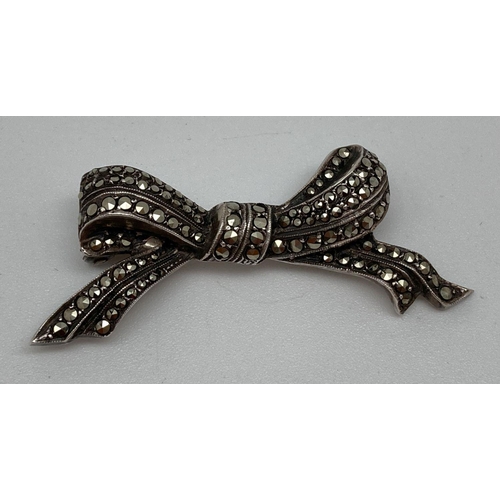 76 - A vintage silver and marcasite set bow shaped brooch. Back of brooch marked 