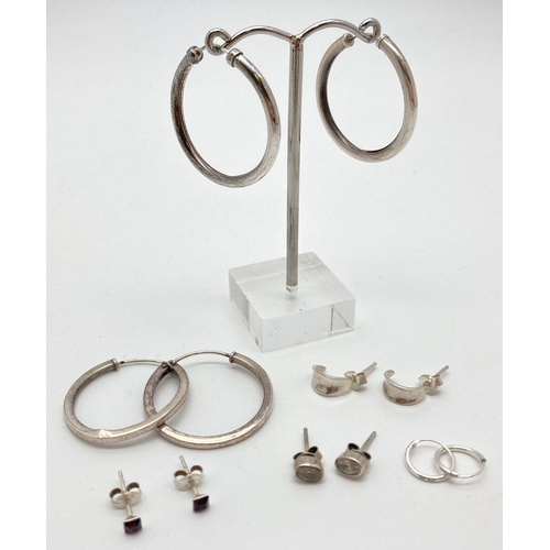 88 - 6 pairs of silver and white metal earrings in stud and hoop style. To include oval clear stone set s... 