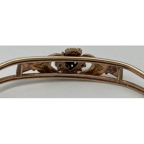 106 - A 9ct gold Claddagh cuff style bracelet set with heart shaped black sapphire. Surrounded by cubic zi... 