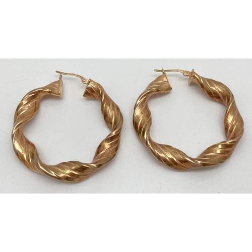 109 - A pair of large 9ct gold twist design hoop earrings. Hallmarks to posts. Total weight approx. 5.3g. ... 