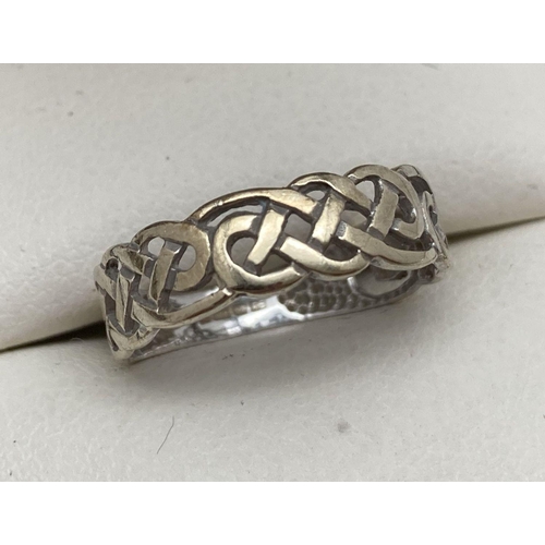 111 - A small 9ct gold band ring with Celtic pierced work design. Full hallmarks to inside of band. Ring s... 