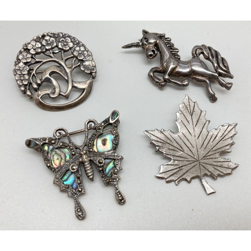 116 - 4 silver and white metal brooches. A vintage maple leaf marked 