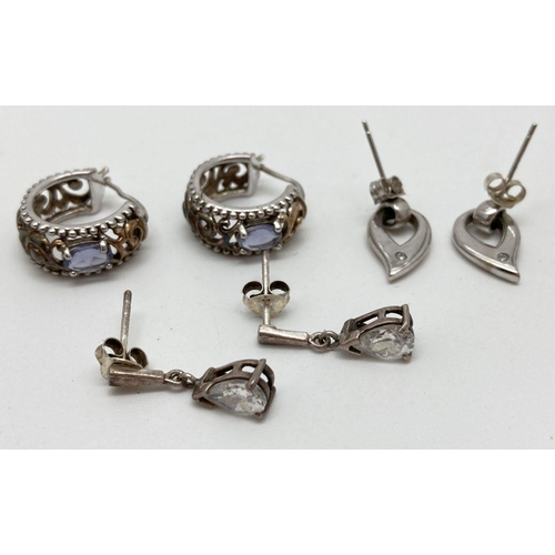 127 - 3 pairs of silver and white metal stone set earrings. A pair of teardrop shaped drops each set with ... 