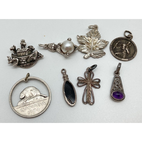 135 - 8 silver and white metal pendants/charms to include Noah's Ark, bird claw holding a faux pearl, Celt... 