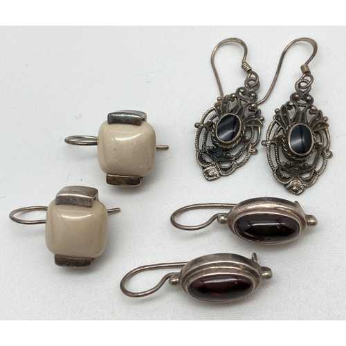 136 - 3 pairs of modern design stone set silver drop style earrings. Oval drops set with garnet cabochon s... 