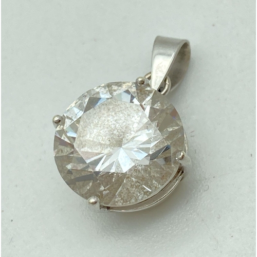 148 - A large round cut clear stone pendant set in a 9ct white gold mount with pierced work petal detail t... 