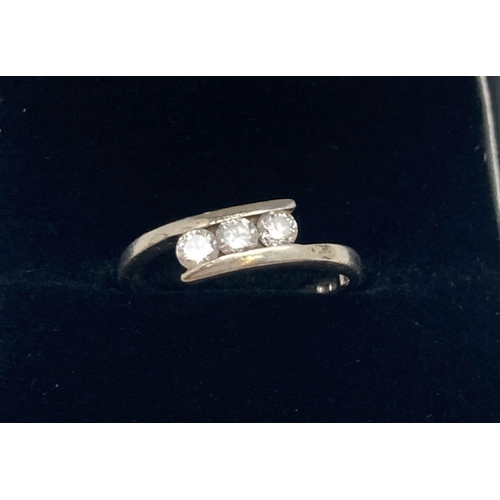 166 - A 9ct white gold dress ring set with 3 tension set diamonds, approx. .20ct. Ring size L.