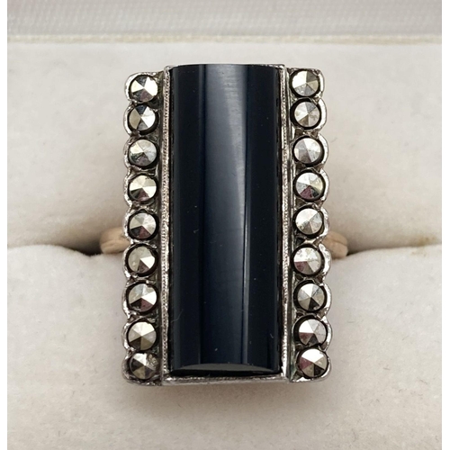 173 - A vintage Art Deco style cocktail ring with large dome topped rectangular onyx stone. Flanked by 2 r... 