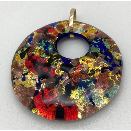 174 - A large contemporary design foil glass pendant with a hallmarked 9ct gold bale. Approx. 5cm diameter... 