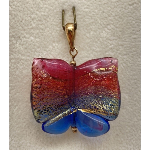 175 - A coloured foil glass pendant in the shape of a butterfly, with a 9ct gold bale. Approx. 4cm long (i... 