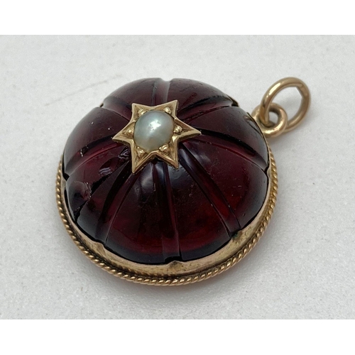 180 - An Edwardian dome shaped red glass fob set with a pearl in a star shaped setting. Glazed reverse pan... 