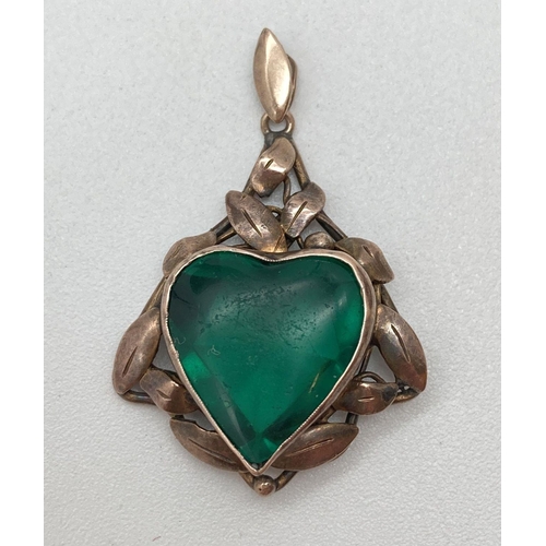 182 - An Edwardian 9ct gold pendant of foliate design set with heart shaped green glass. Marked 9ct to rev... 