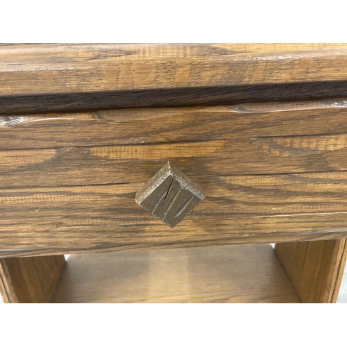 1375 - A mid Century Brandt Ranch Oak single drawer occasional stand with rough hewn design carved into dra... 