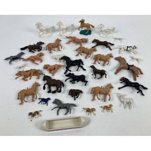 1225 - A collection of vintage plastic horse figures in varying colours, to include examples by Britains.