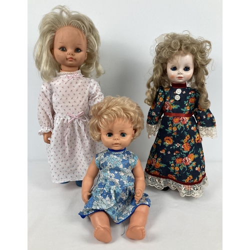 1235 - 3 vintage vinyl dolls. A baby doll by Chiltern with closing eyes and blue floral dress, a Katie Copy... 