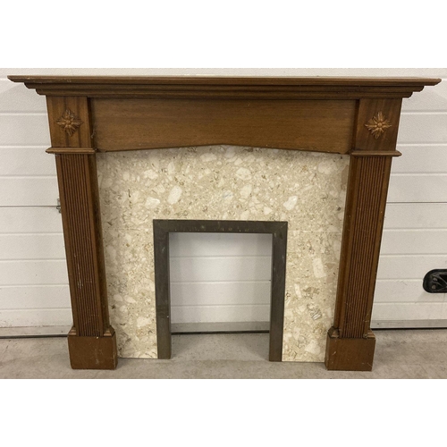 1379 - A cream marble and brass fire surround with carved wooden mantle. Column detail and carved floral ap... 